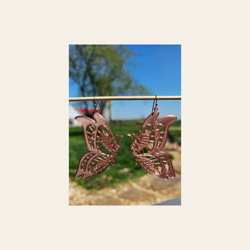 3D Print Butterfly Boho Earrings on a warm cream background