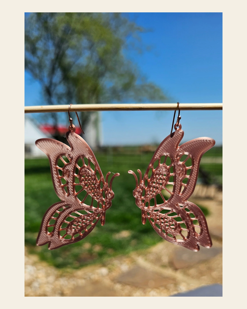 3D Print Butterfly Boho Earrings on a warm cream background