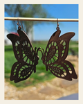 3D Print Butterfly Boho Earrings on a warm cream background