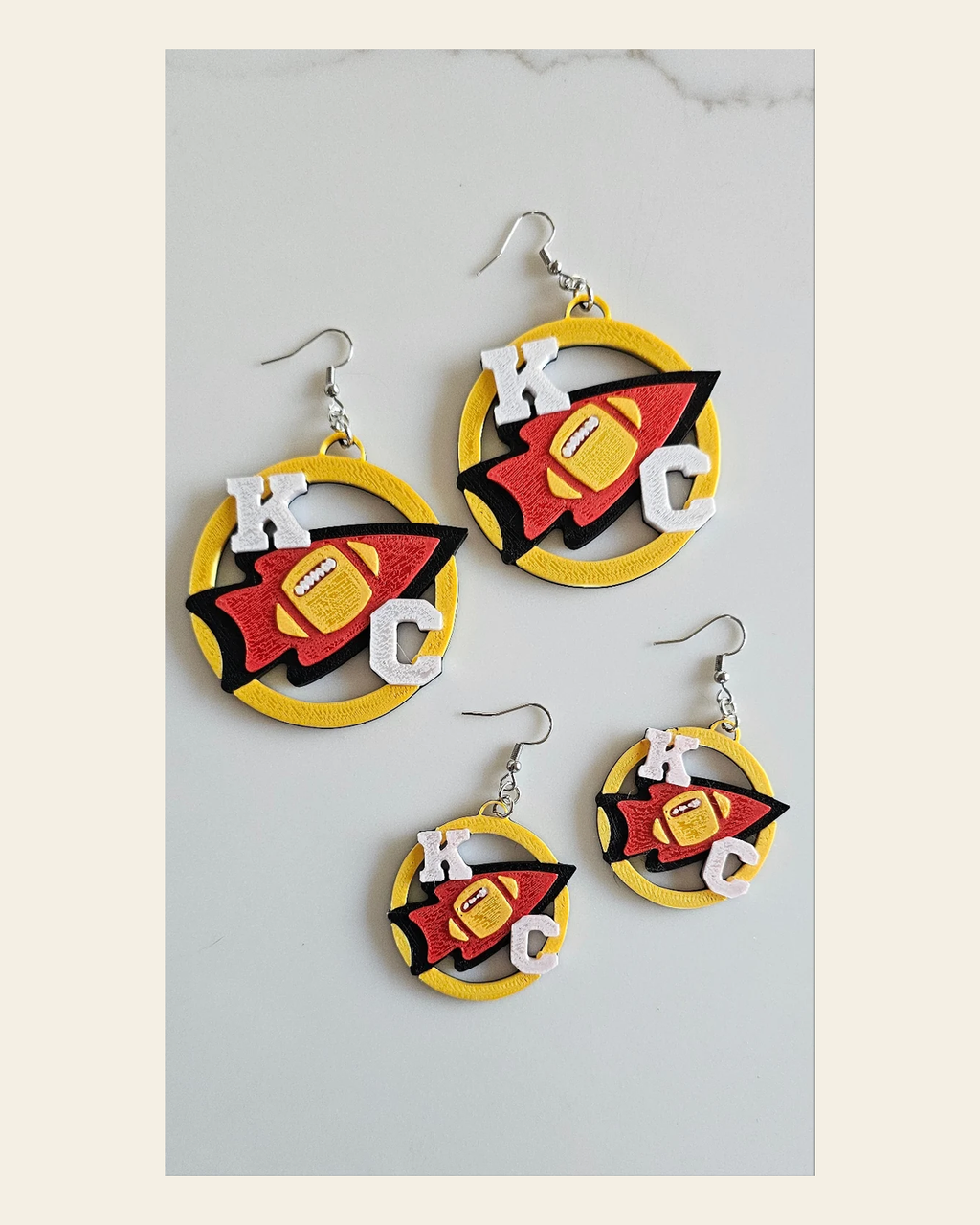 3D Print Chiefs Earrings Keychain Red Kingdom Kansas City KC Football on a warm cream background