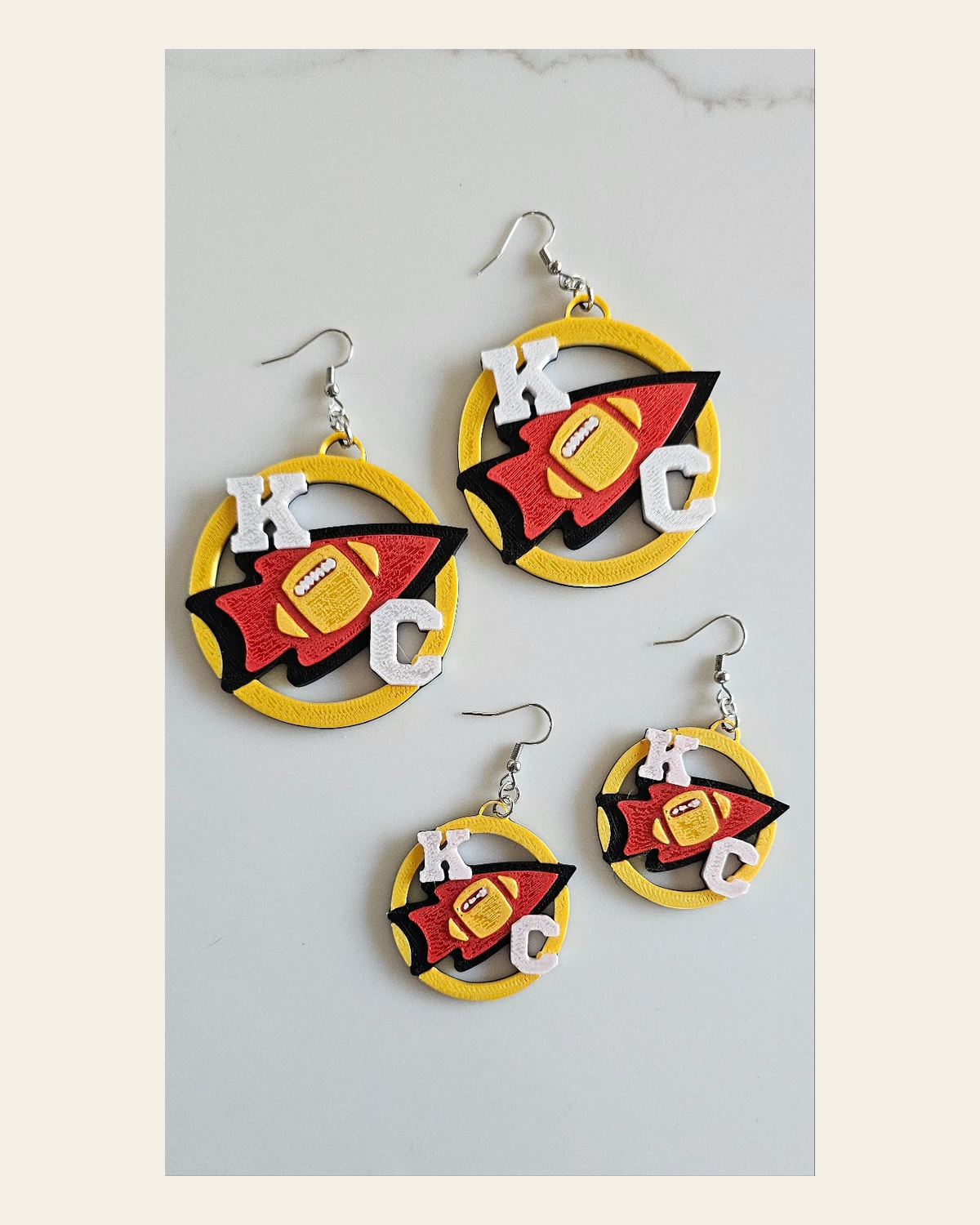 3D Print Chiefs Earrings Keychain Red Kingdom Kansas City KC Football on a warm cream background