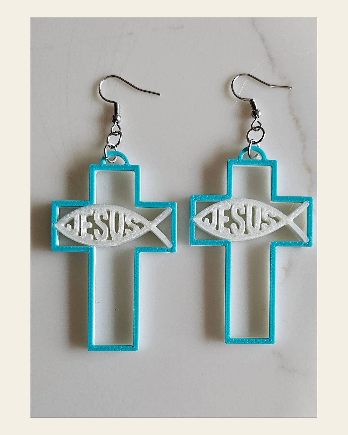 3D Print Christian Cross Faith Earrings Made in America on a warm cream background