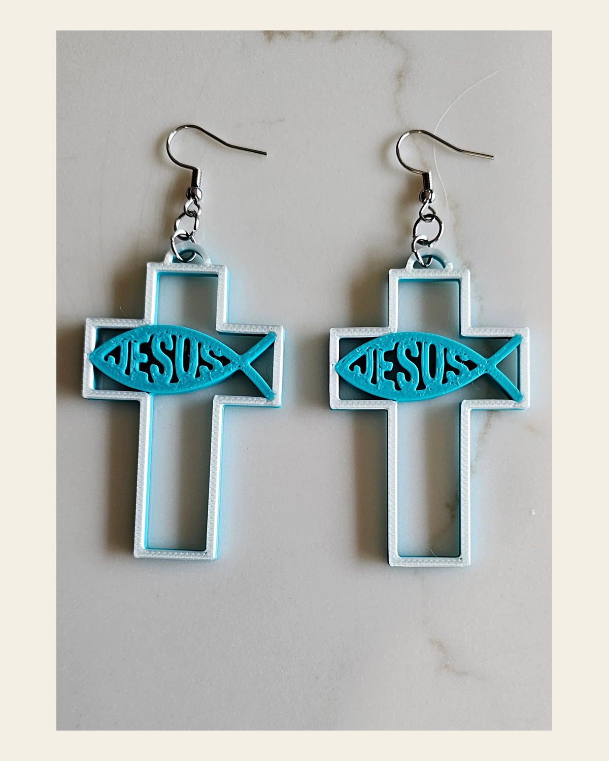 3D Print Christian Cross Faith Earrings Made in America on a warm cream background