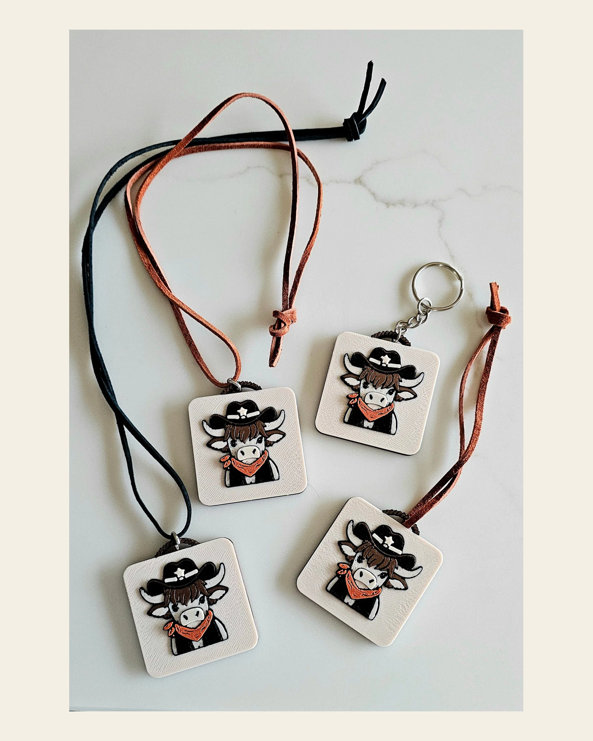 3D Print Cowboy Highland Cow Picture Necklace, Keychain or Purse Charm on Suede Leather Western Made in America on a warm cream background