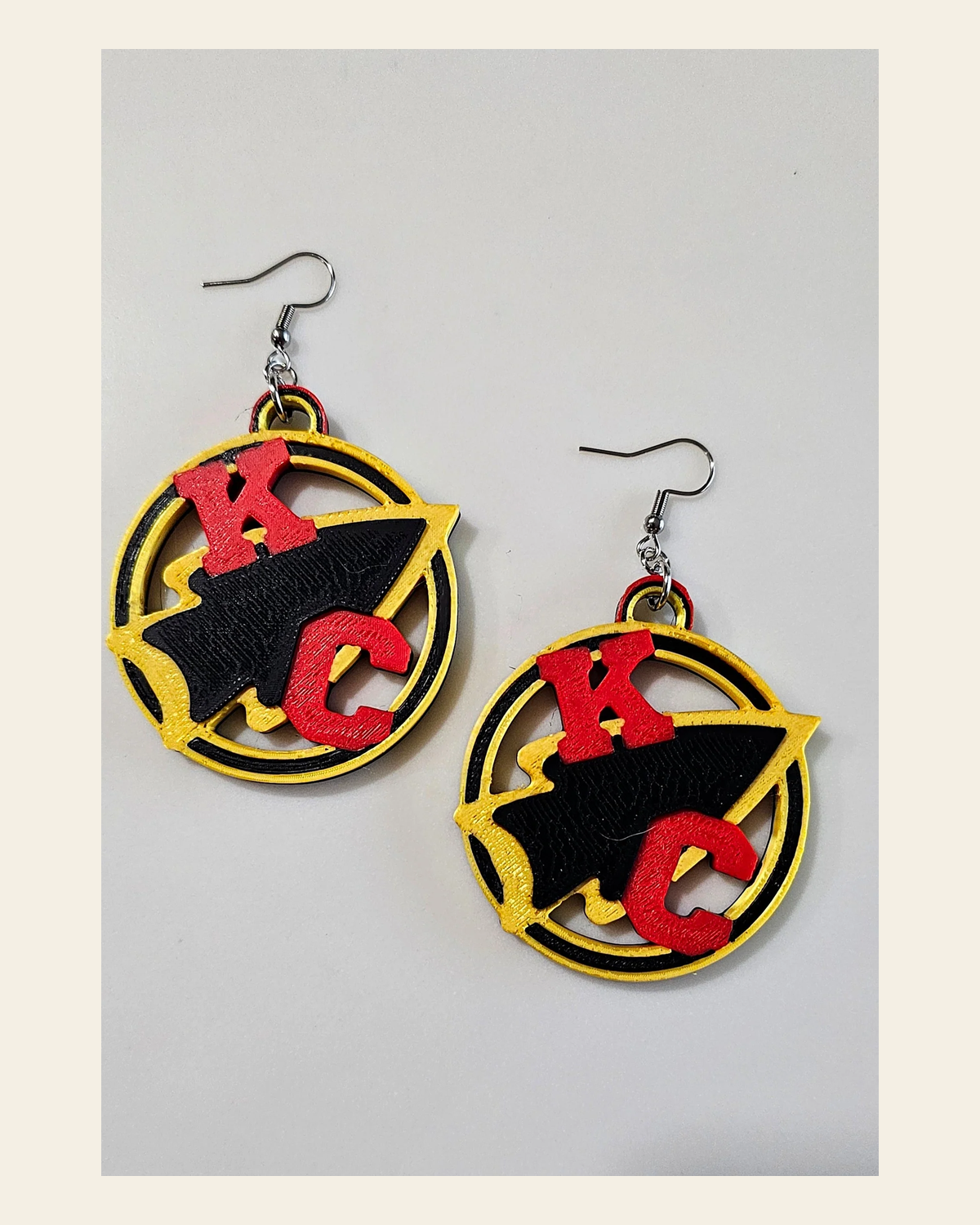 3D Print Kansas City Arrowhead Football Chiefs Earrings Made in America on a warm cream background