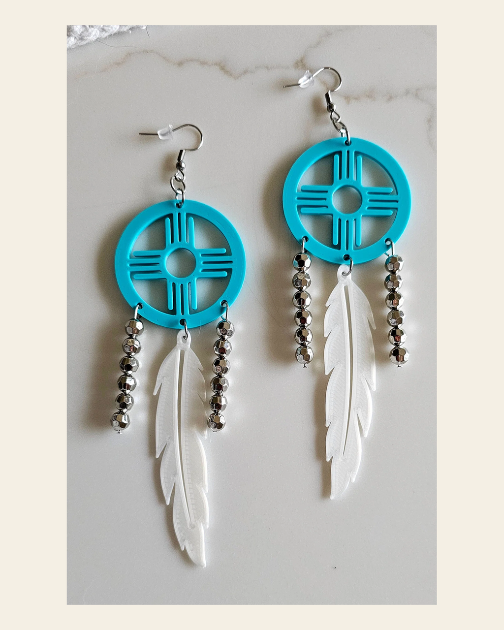 3D print Lightweight Turquoise New Mexico Zia Feather Dream Catcher Earrings Made in America on a warm cream background