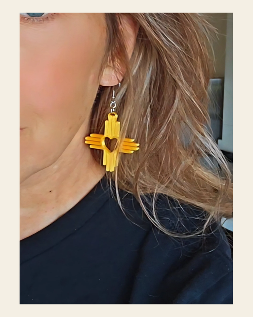 3D Print New Mexico Zia Earrings Made in America on a warm cream background
