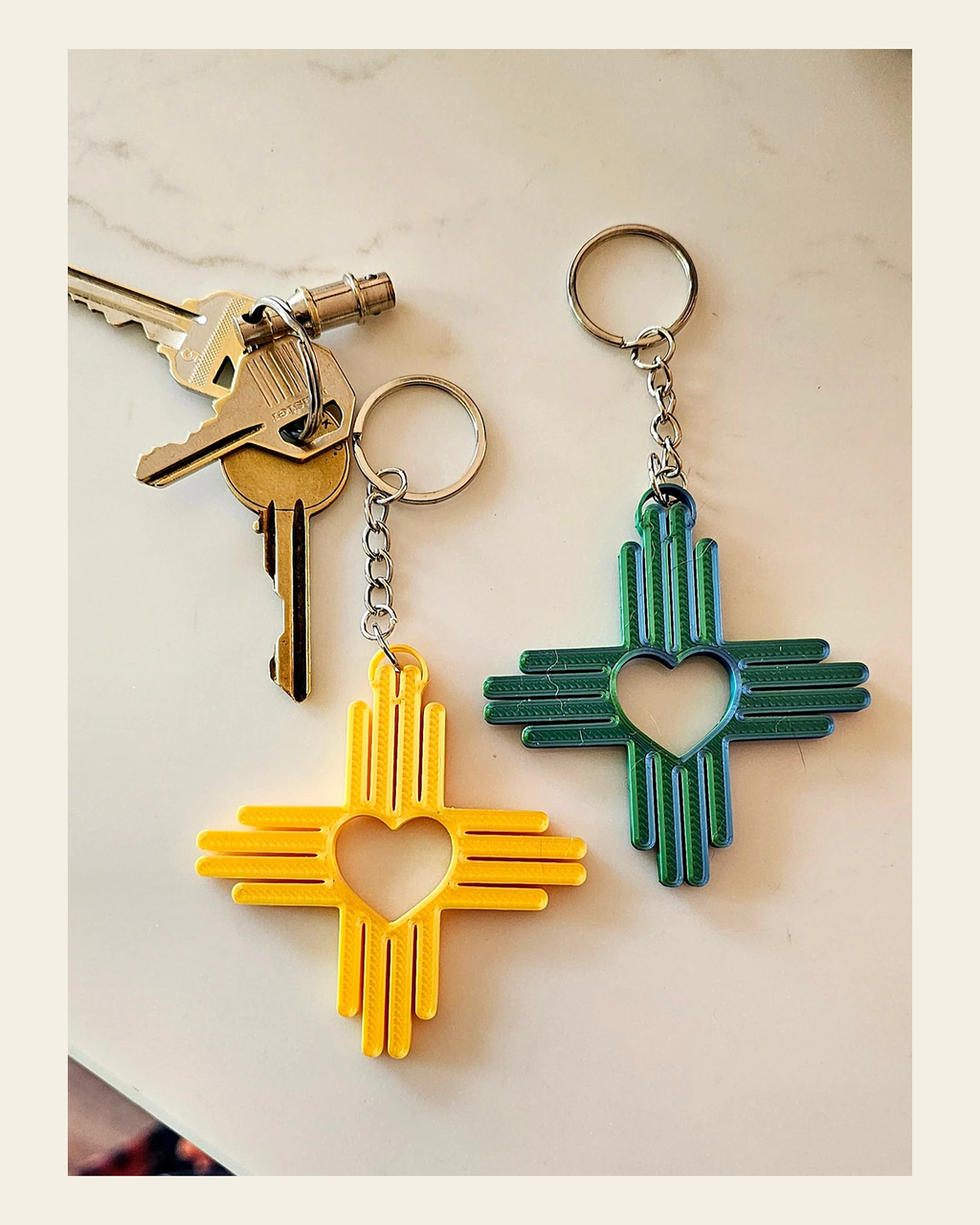 3D Print New Mexico Zia Heart Keychain Made in America on a warm cream background