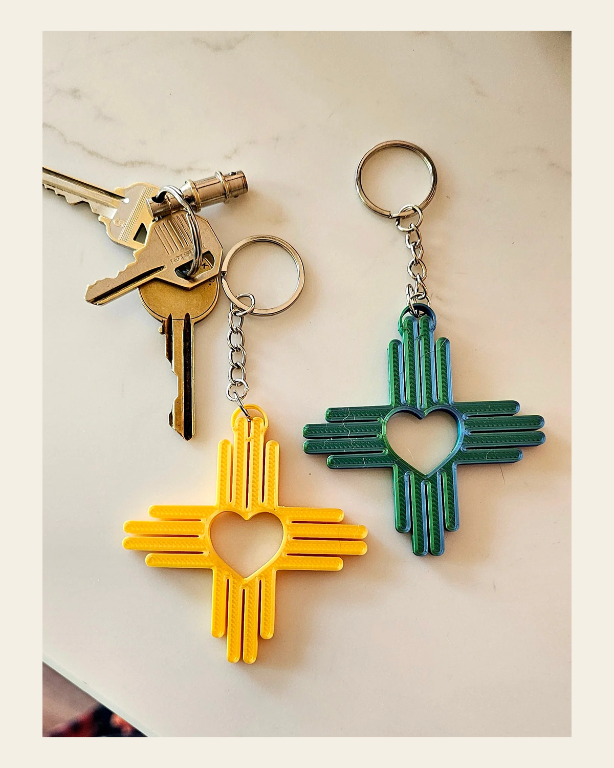 3D Print New Mexico Zia Heart Keychain Made in America on a warm cream background
