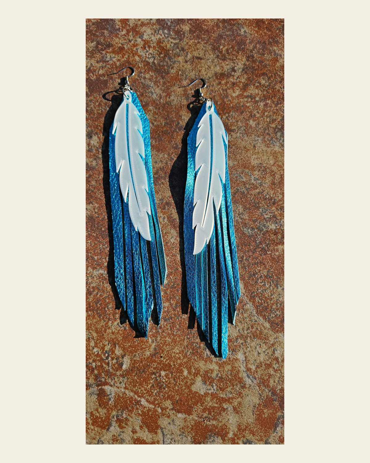 3D Printed Feather Leather Fringe Earrings Made in America on a warm cream background