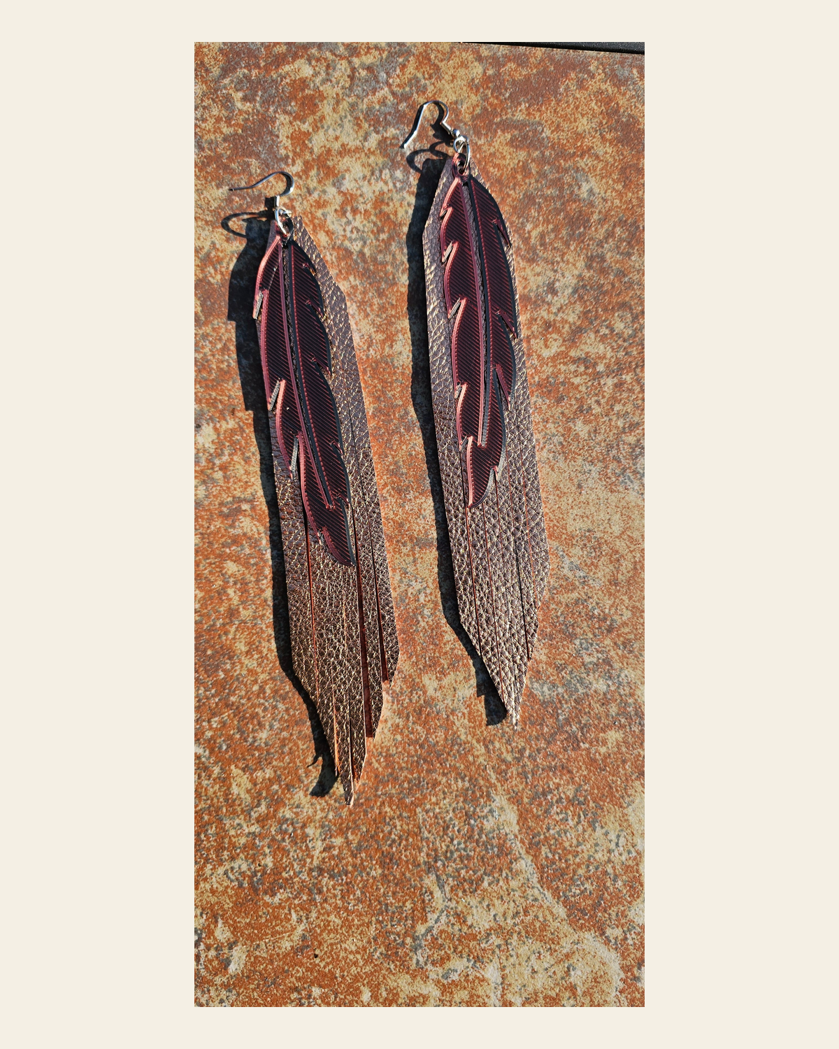 3D Printed Feather Leather Fringe Earrings Made in America on a warm cream background
