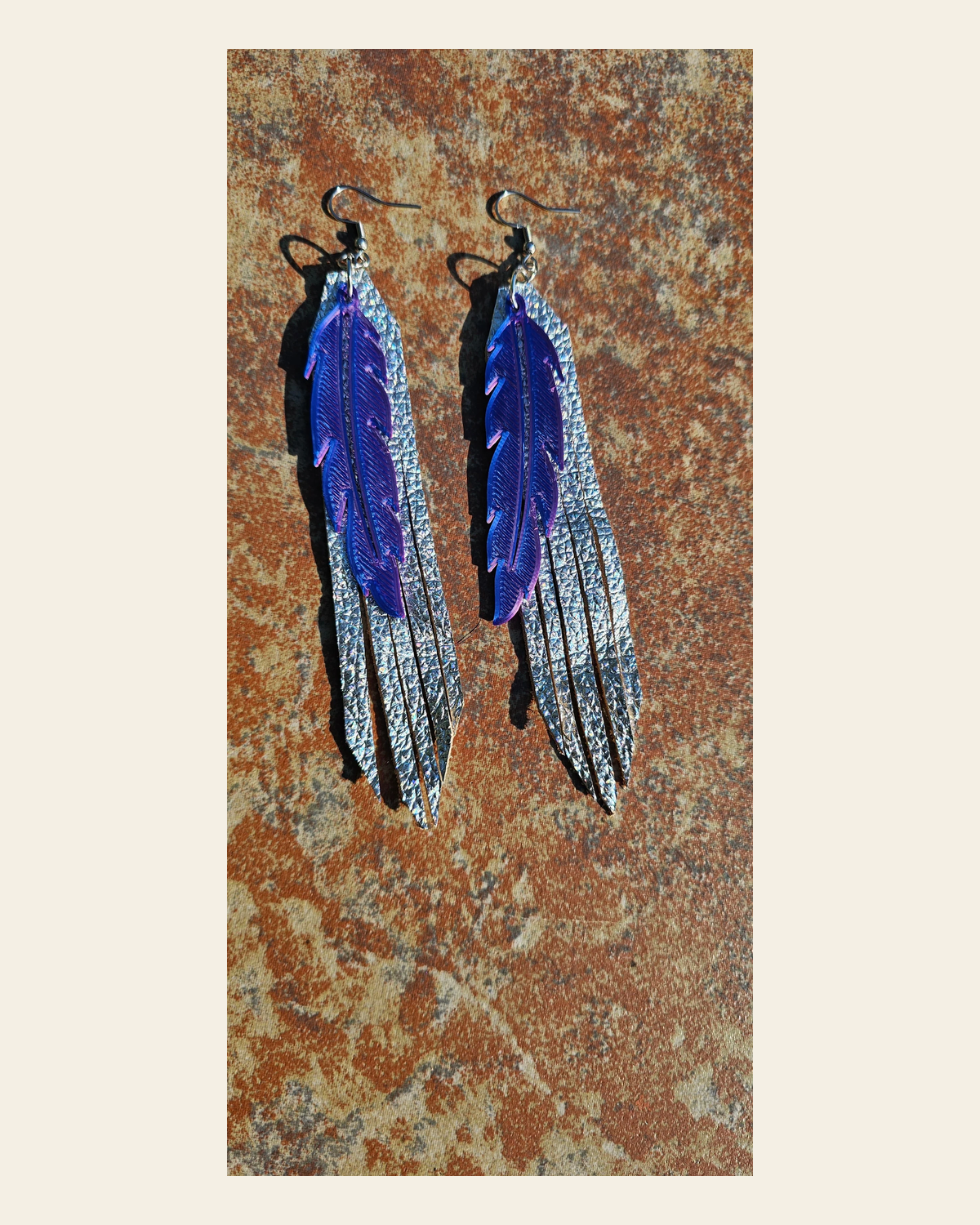 3D Printed Feather Leather Fringe Earrings Made in America on a warm cream background