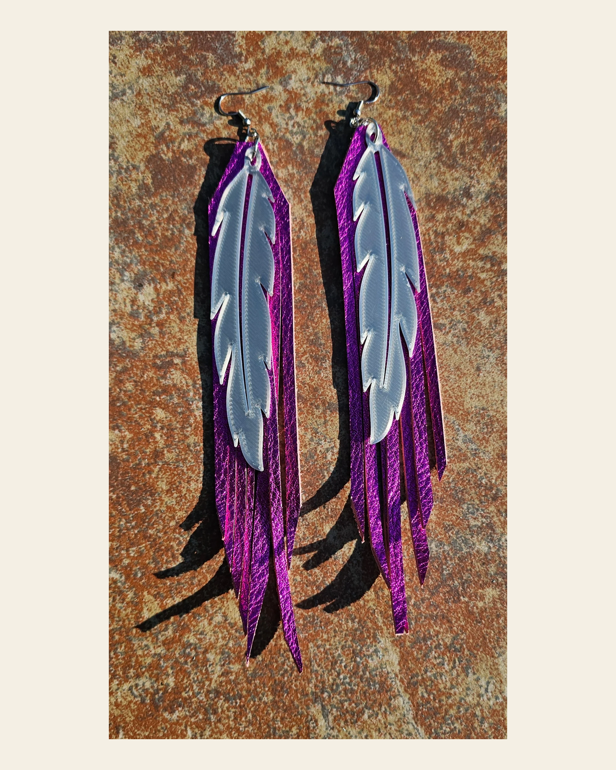 3D Printed Feather Leather Fringe Earrings Made in America on a warm cream background