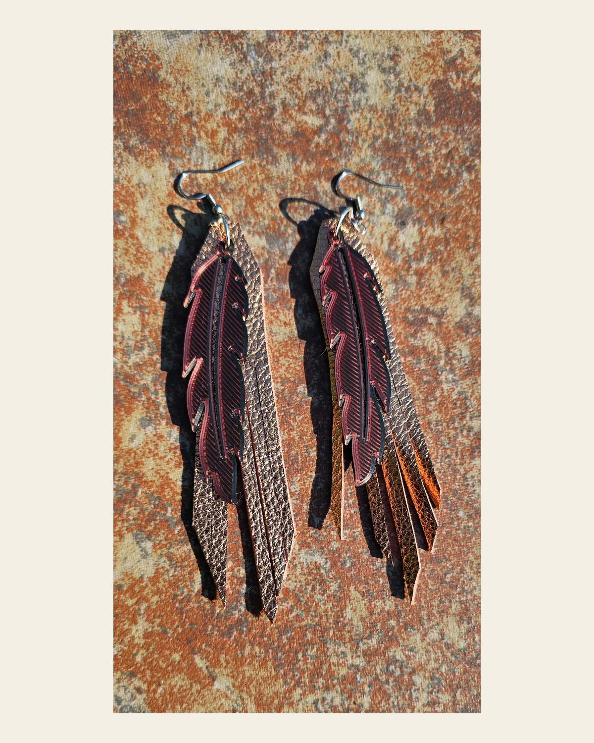 3D Printed Feather Leather Fringe Earrings Made in America on a warm cream background