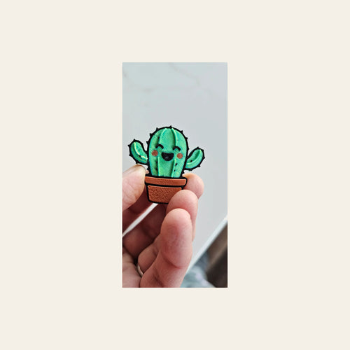 3d Happy Cactus Hat Pin on a warm cream background