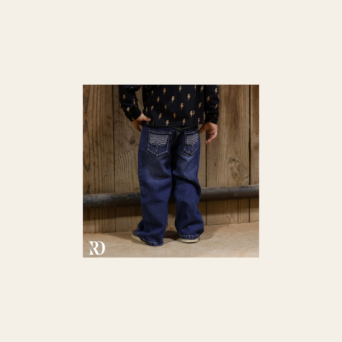 Bam Bootcut - Dark Wash Toddler Boy Denim on a warm cream background