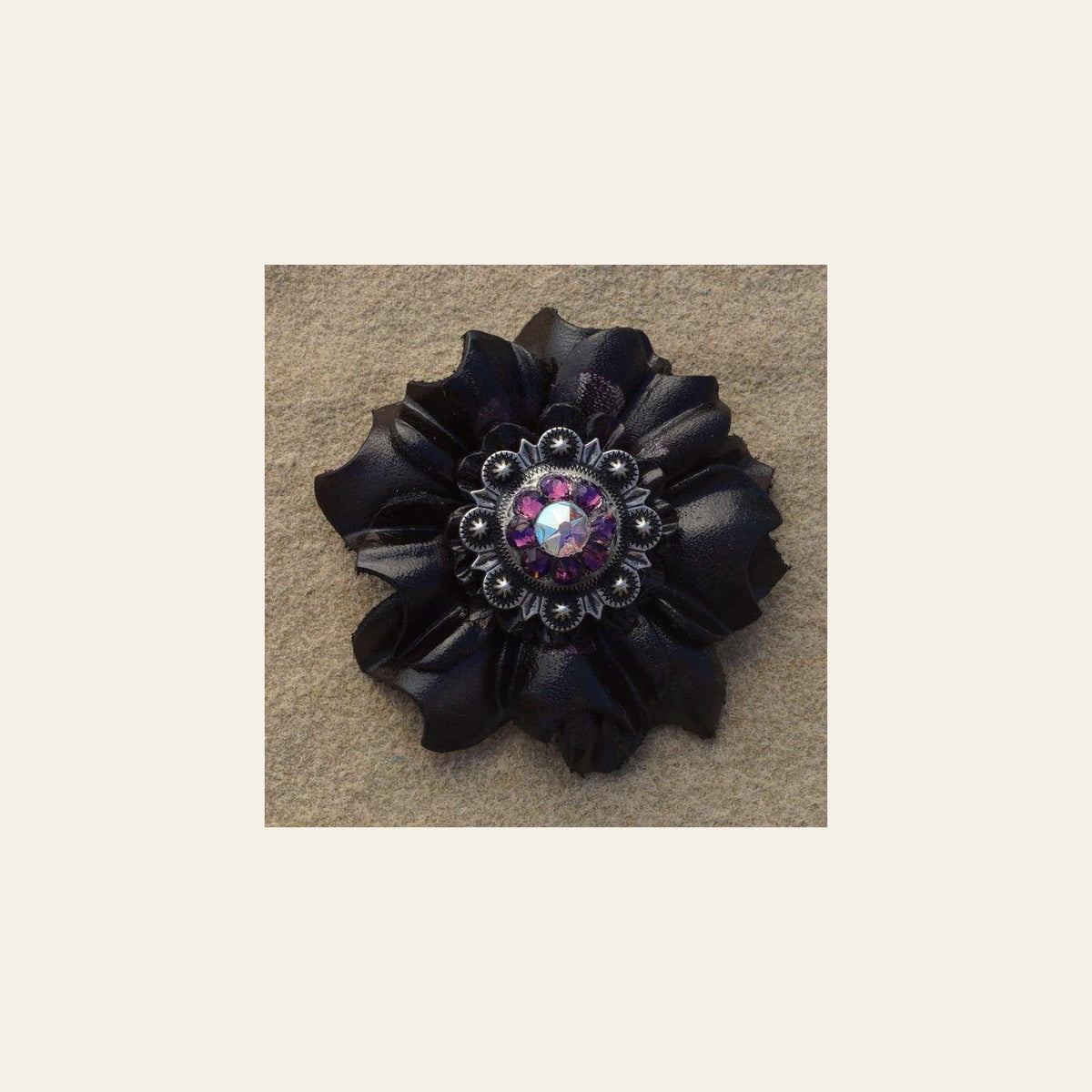 Black Carnation Flower With Antique Silver Amethyst and AB 1" Concho on a warm cream background