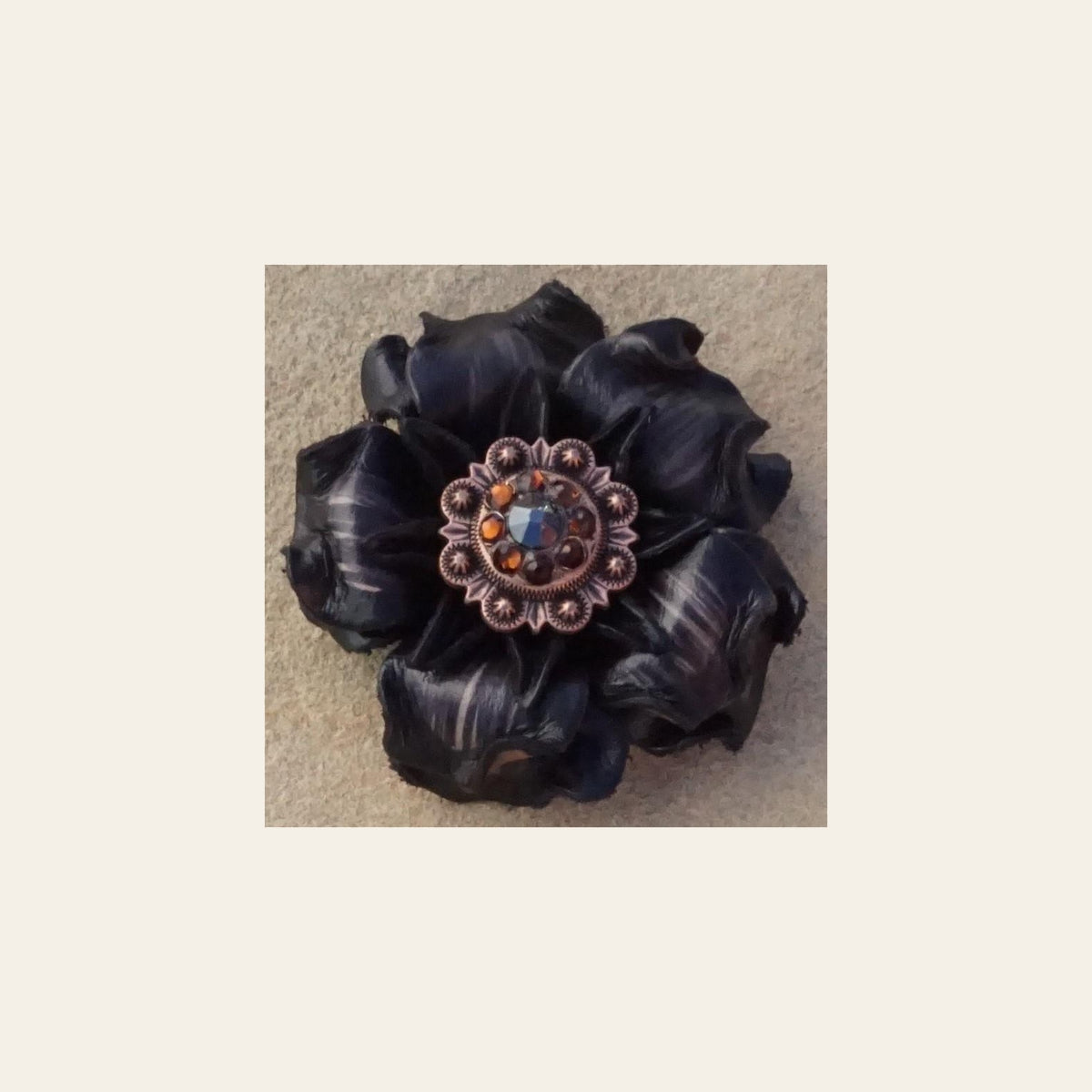 Black Gardenia Flower With Copper Black & Topaz 1" Concho on a warm cream background