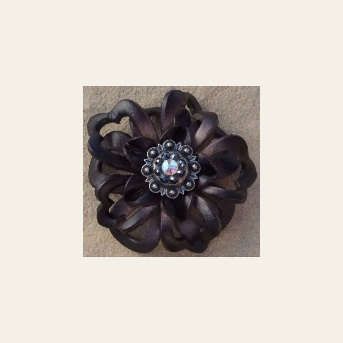 Black Lotus Flower With Antique Silver Jet and AB 1" Concho on a warm cream background