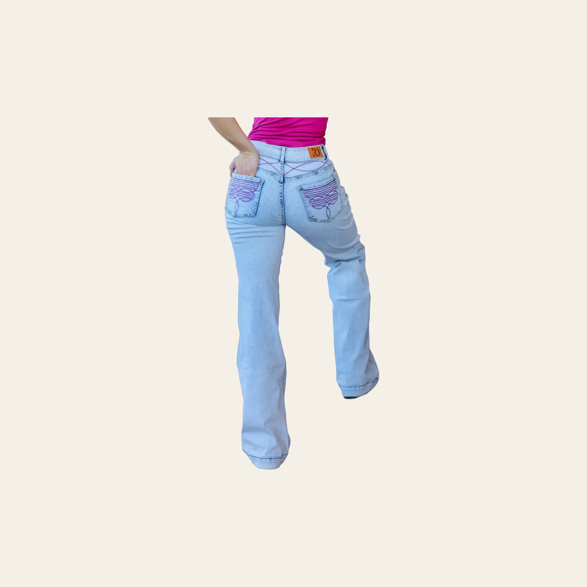 Cheyenne Trousers - Light Wash Pink Pocket on a warm cream background