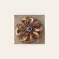 Gold Lotus Flower With Antique Silver Topaz and Champagne 1" Concho on a warm cream background