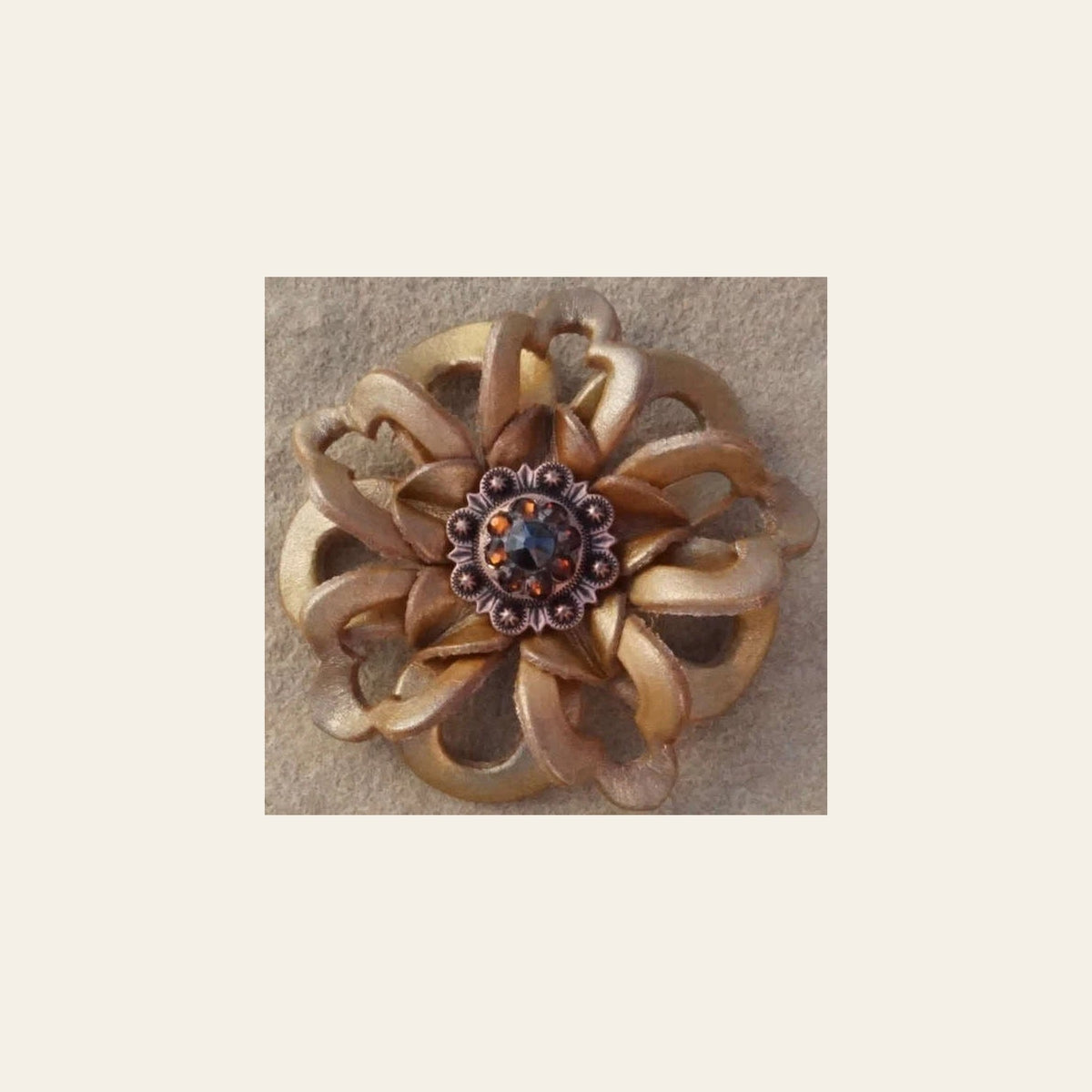 Gold Lotus Flower With Copper Jet and Topaz 1" Concho on a warm cream background