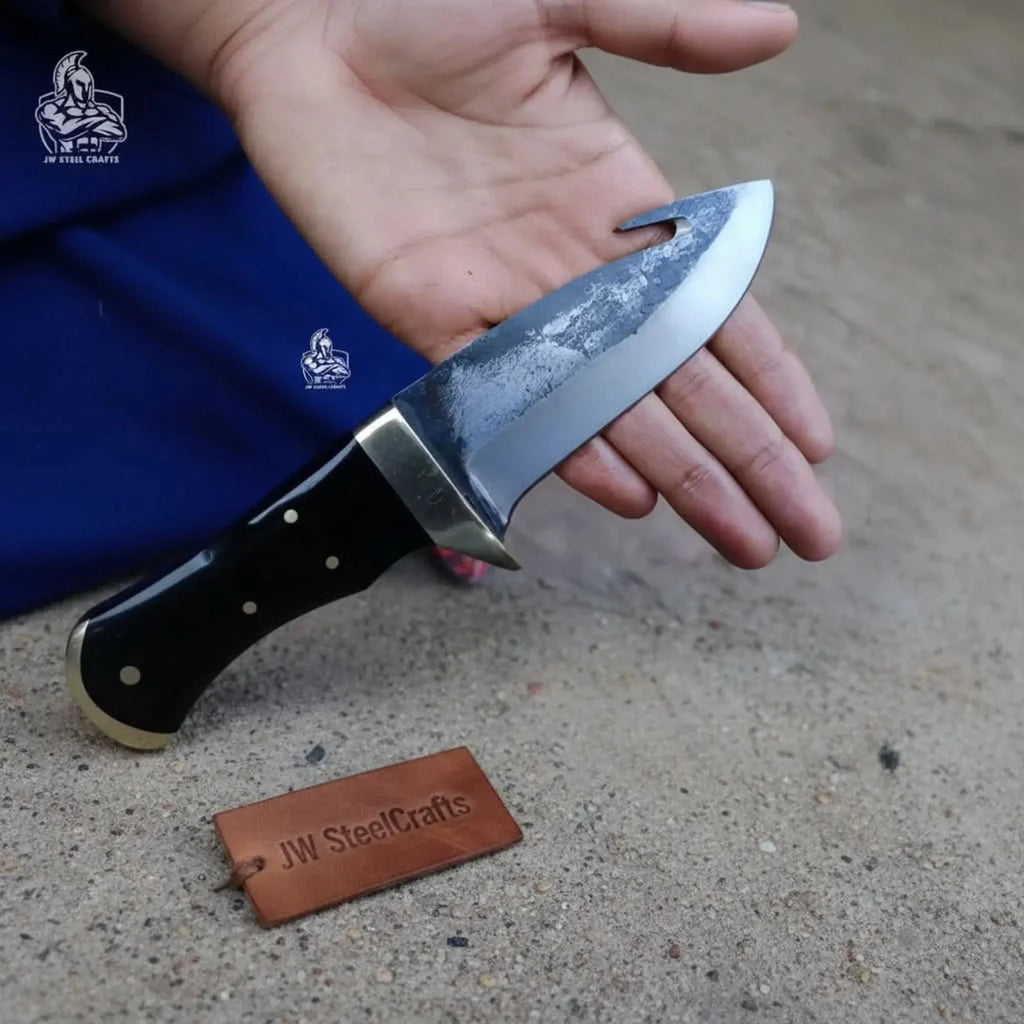 Gut hook knife with wood and brass handle.