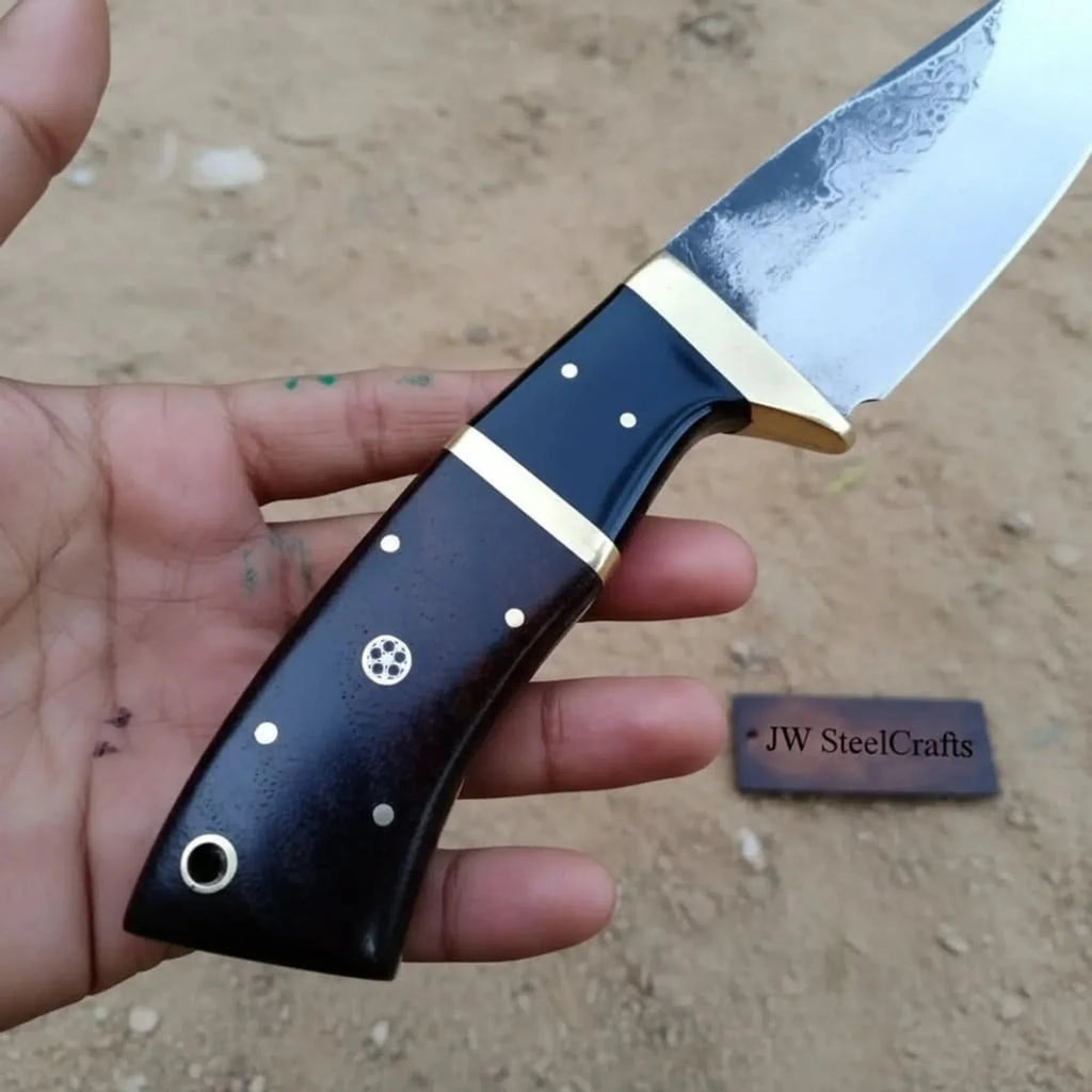 Gut hook knife with wood and brass handle.