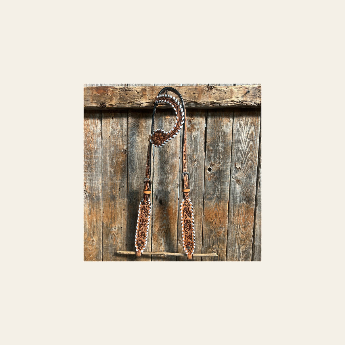 Light Oil Floral Tooled with White Whipstitch One Ear Headstall / Bridle on a warm cream background