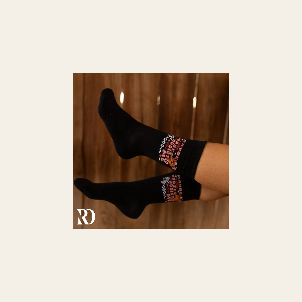 Maybe The Horses Are Addicted To Me Socks on a warm cream background