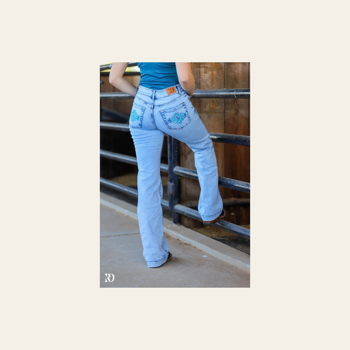 Mia Trousers - Light Wash Turquoise Pocket on a warm cream background