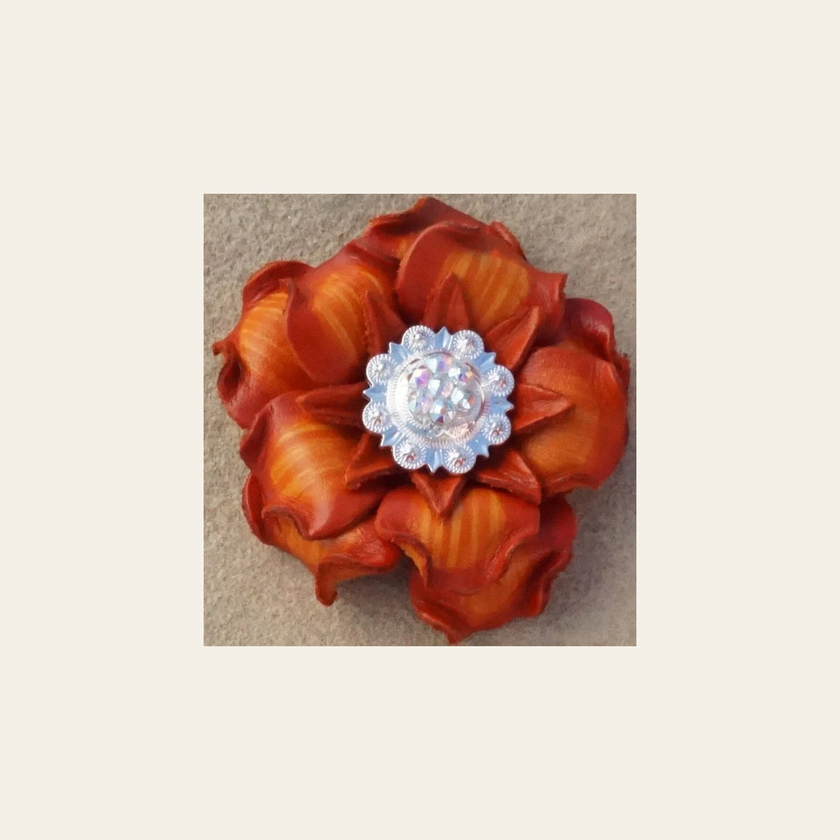 Orange Gardenia Flower With Bright Silver AB 1" Concho on a warm cream background