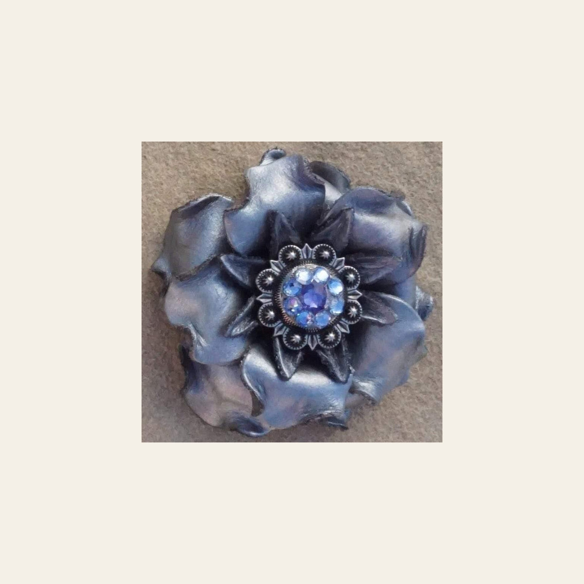 Silver Gardenia Flower With Antique Silver Light Sapphire & Lilac 1" Concho on a warm cream background