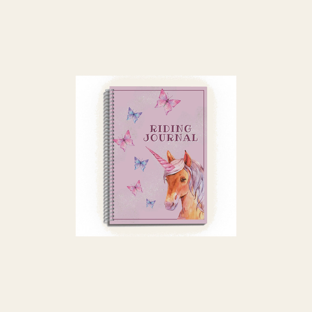 Unicorn Riding Journal on a warm cream background