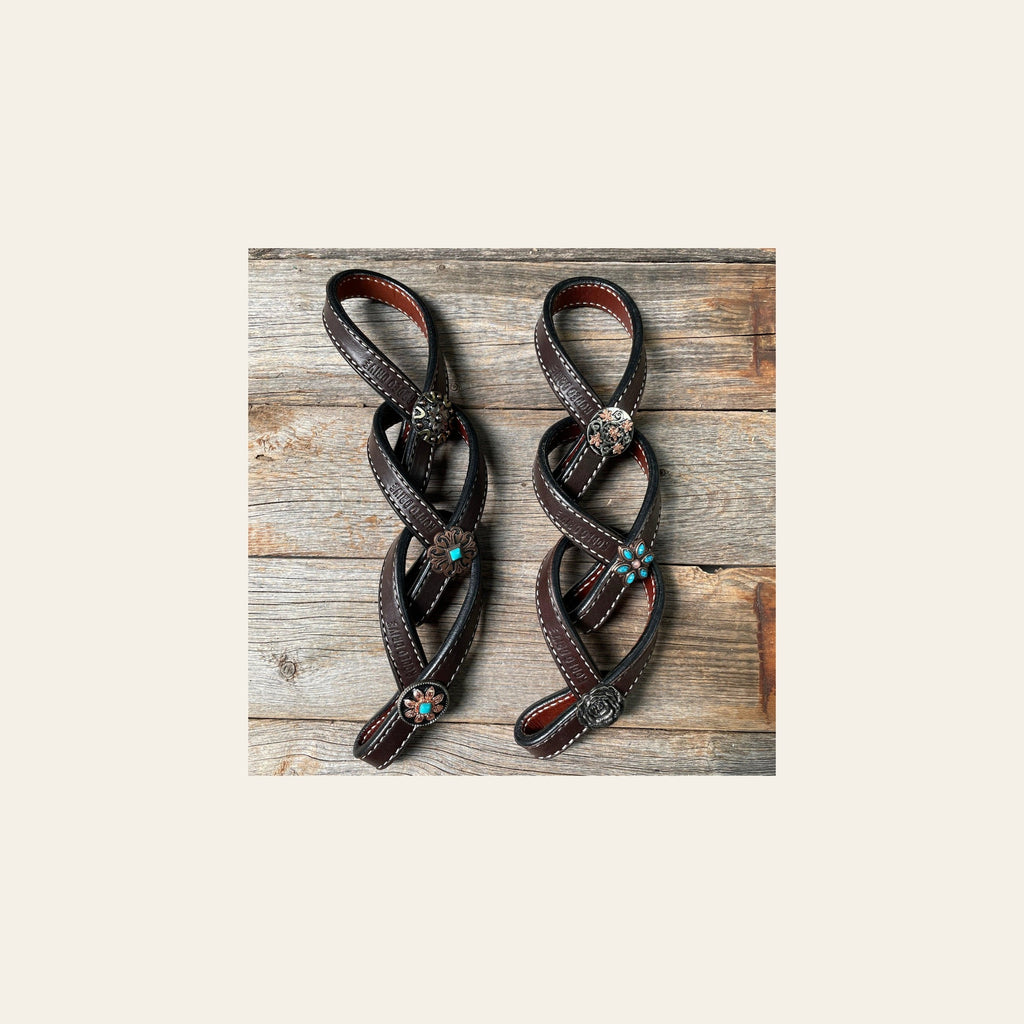 Western Dark Oil Rustic Tie Down Keepers on a warm cream background