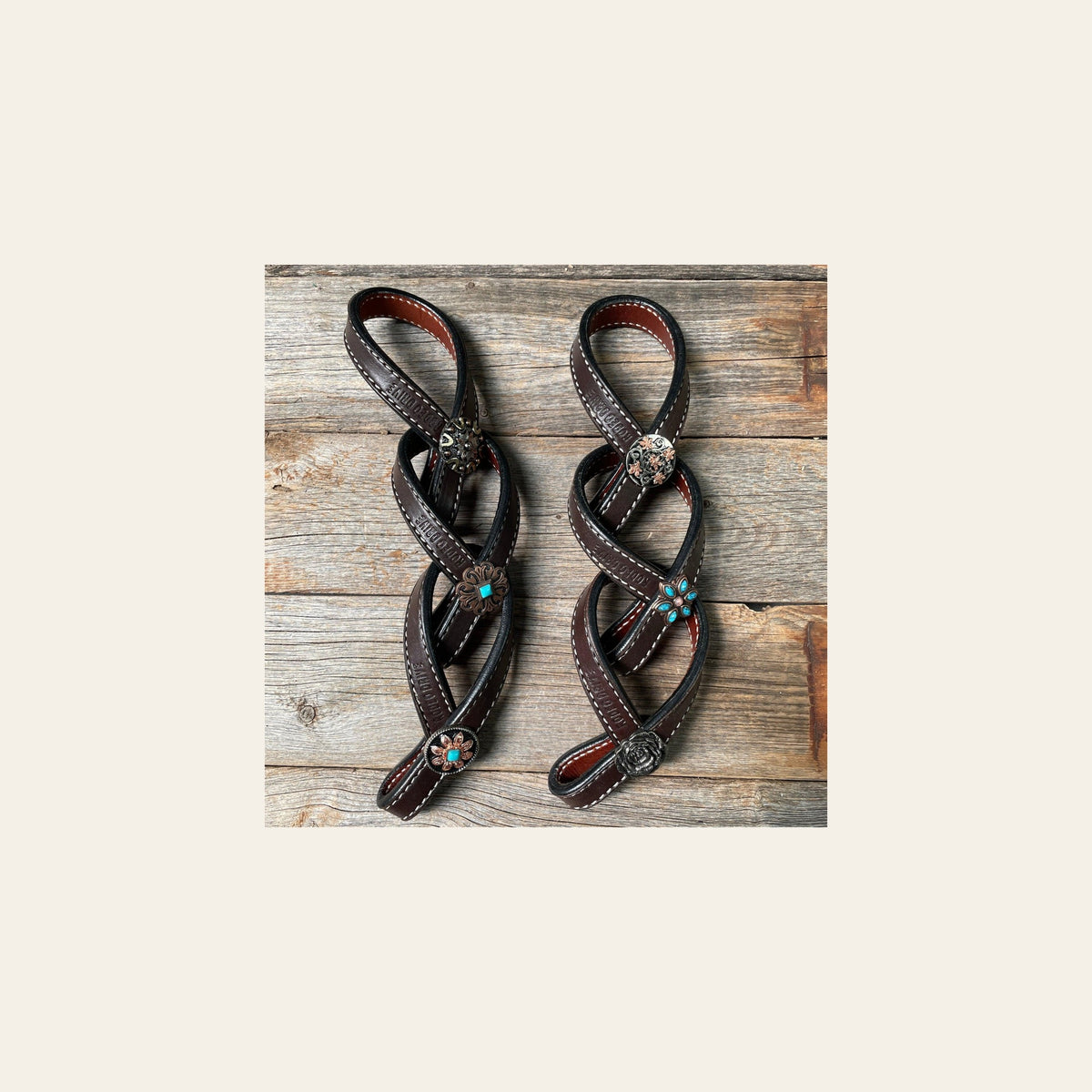 Western Dark Oil Rustic Tie Down Keepers on a warm cream background