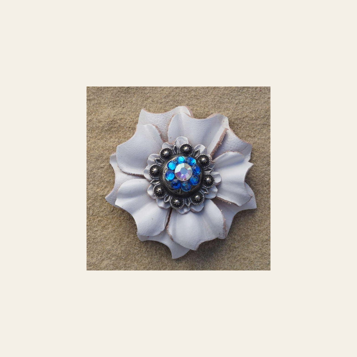 White Carnation Flower With Antique Silver Capri and AB 1" Concho on a warm cream background