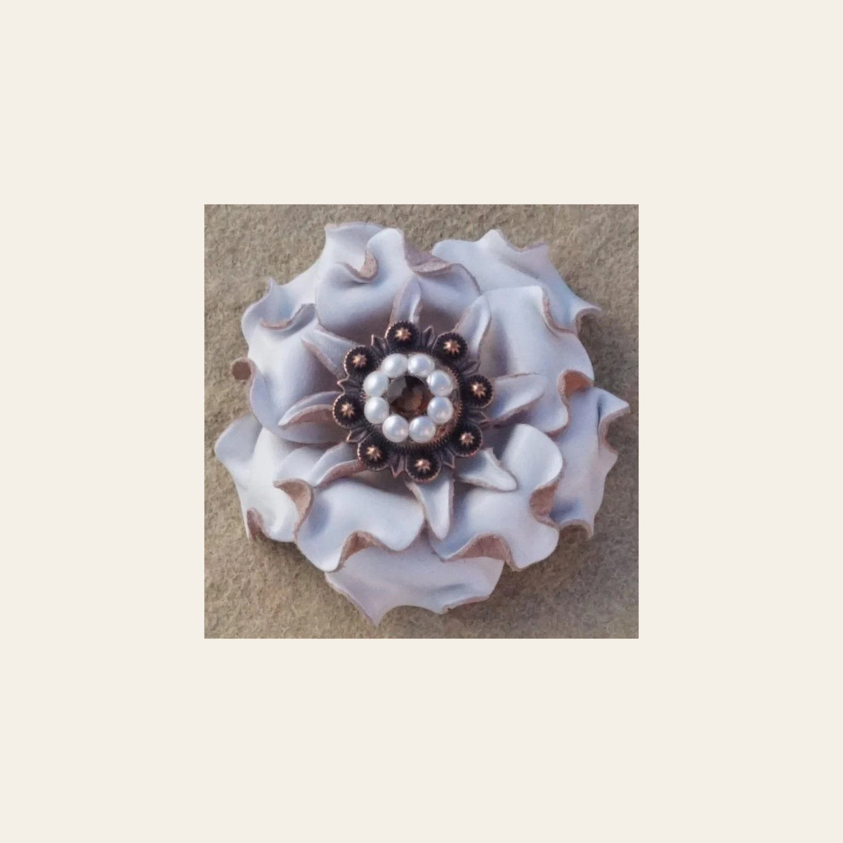 White Gardenia Flower With Copper Topaz & Pearl 1" Concho on a warm cream background