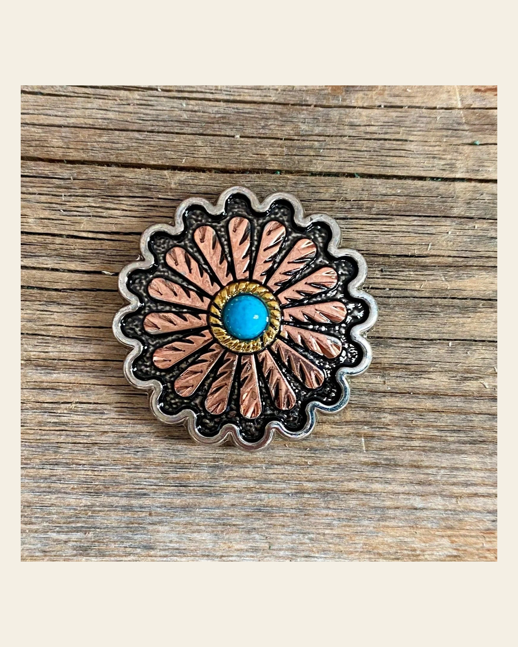Antique Silver and Copper Floral Western Concho 1.25" W220L on a warm cream background