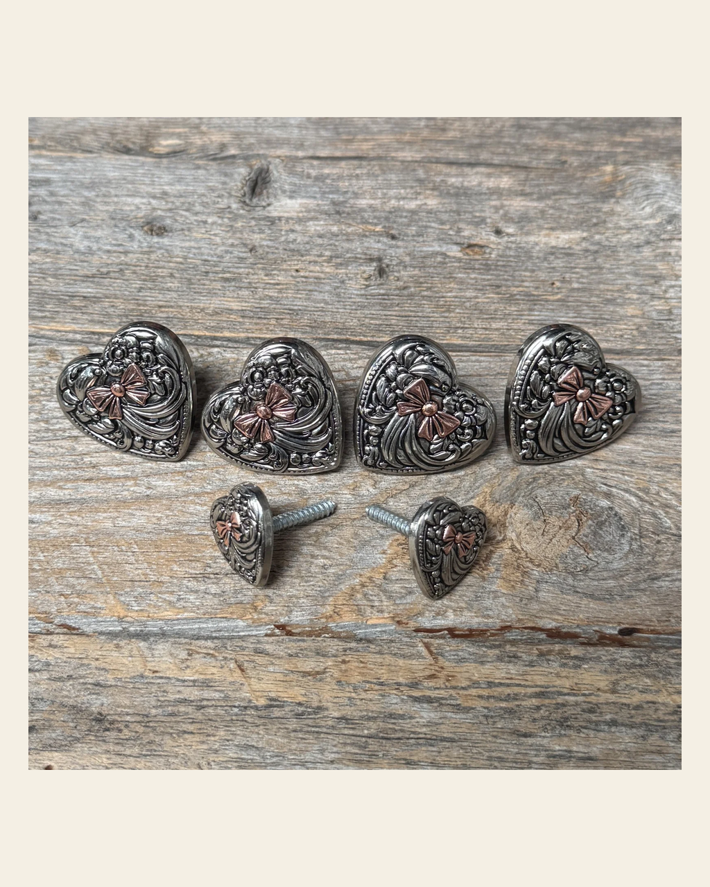 Antique Silver and Copper Heart Saddle Set SSW263 on a warm cream background