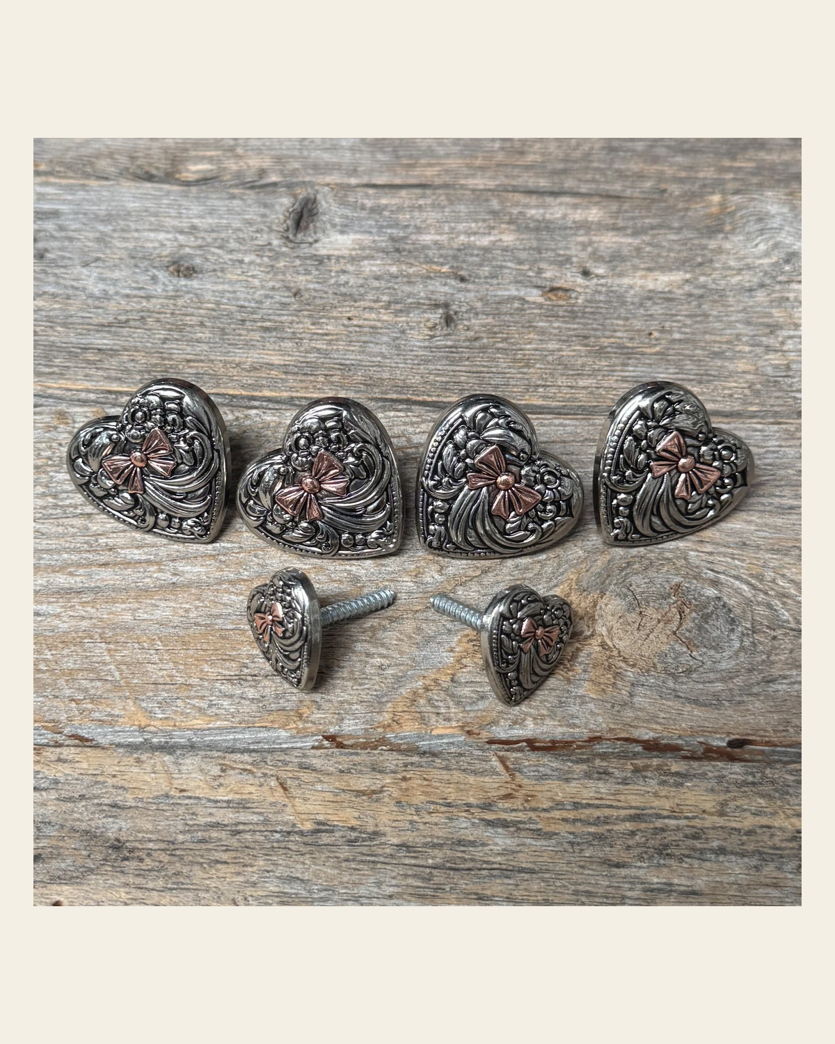 Antique Silver and Copper Heart Saddle Set SSW263 on a warm cream background
