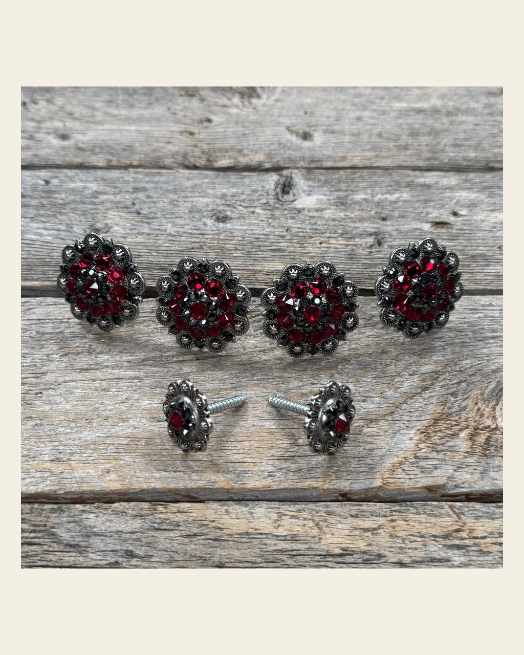 Antique Silver Ruby and Jet Saddle Conchos on a warm cream background