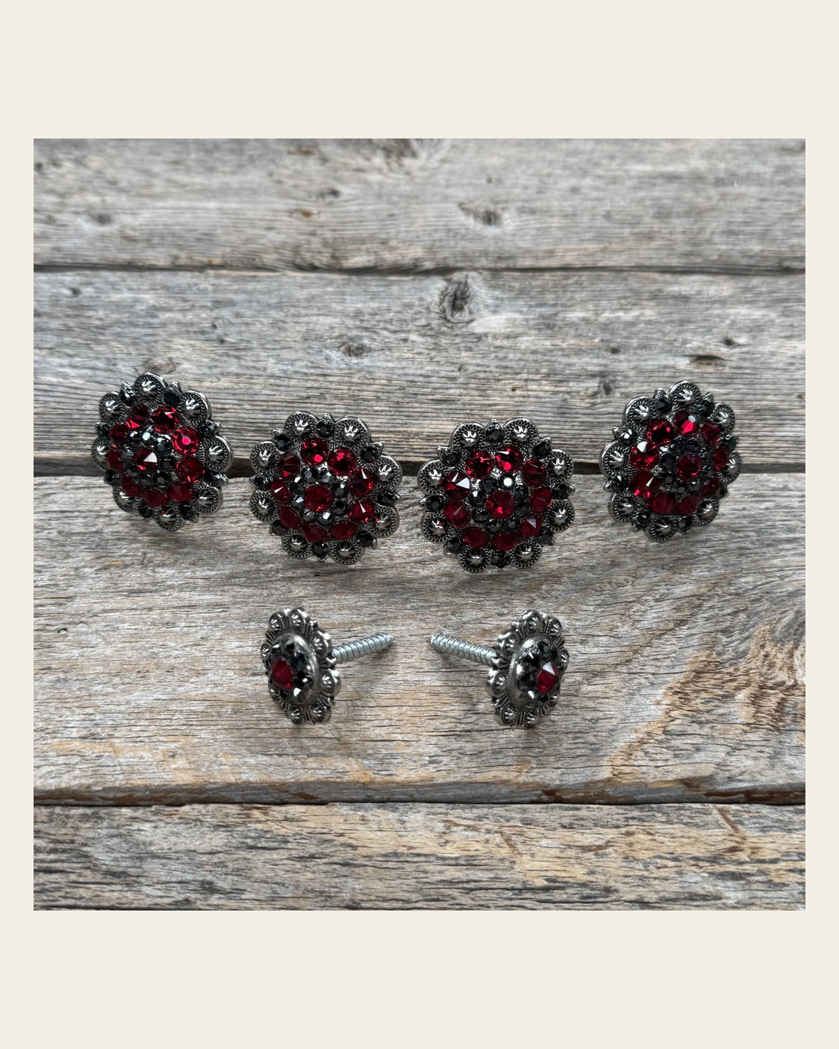 Antique Silver Ruby and Jet Saddle Conchos on a warm cream background