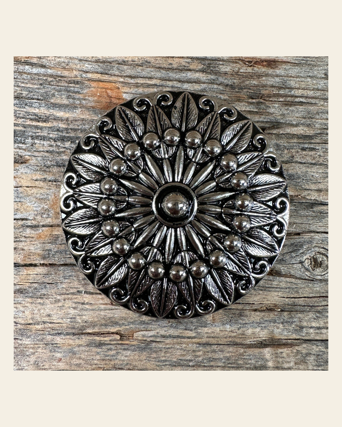 Antique Silver Floral Pinwheel Concho 1.5" W227L on a warm cream background