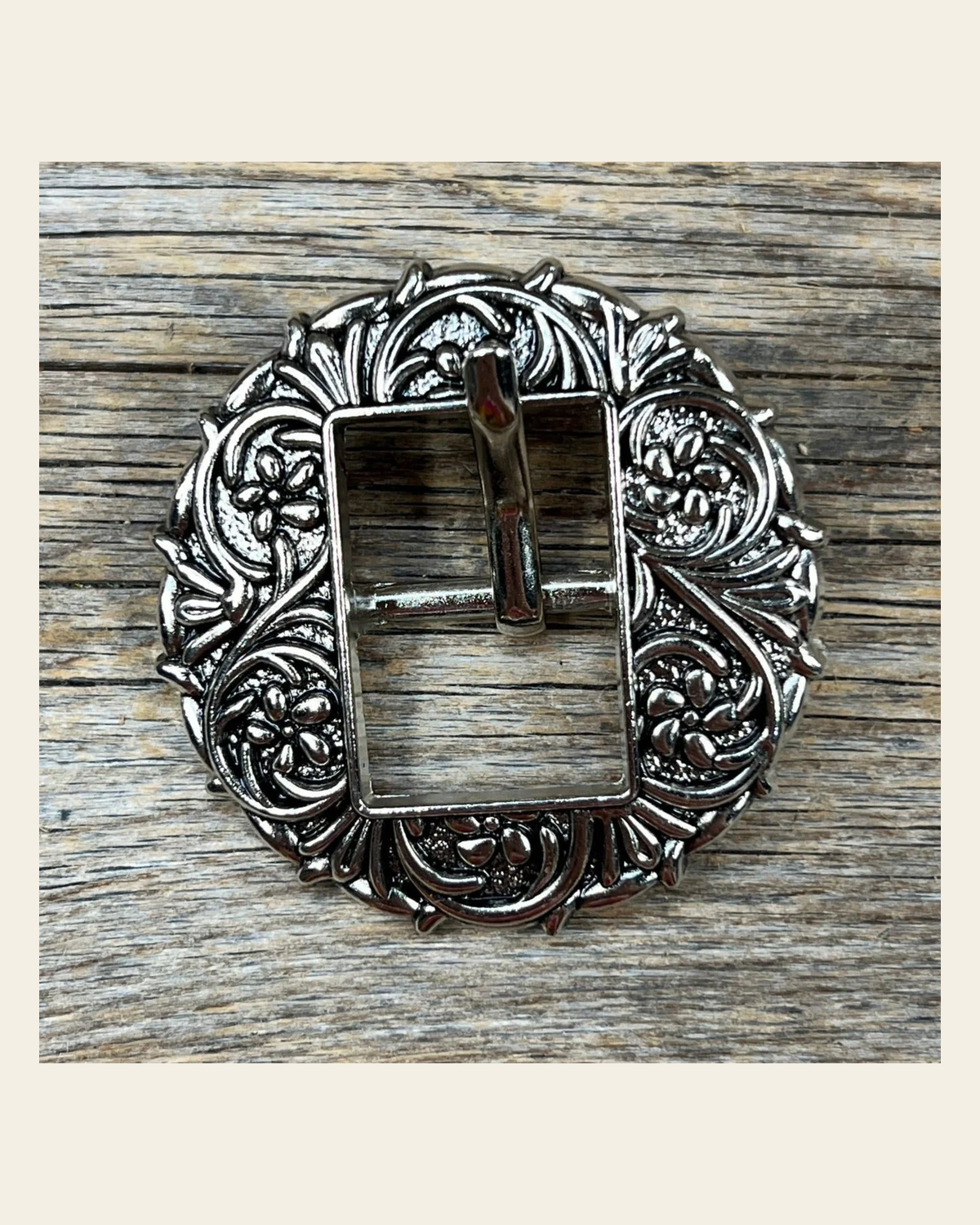 Antique Silver Floral Round Western Buckle W238B on a warm cream background