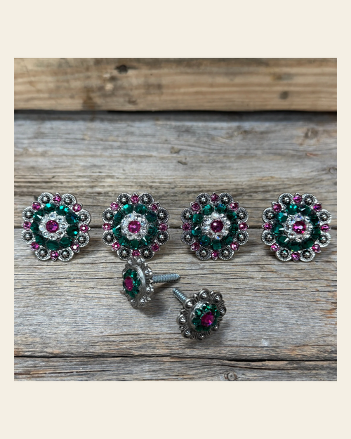 Antique Silver Fuchsia, Clear and Emerald Saddle Conchos on a warm cream background