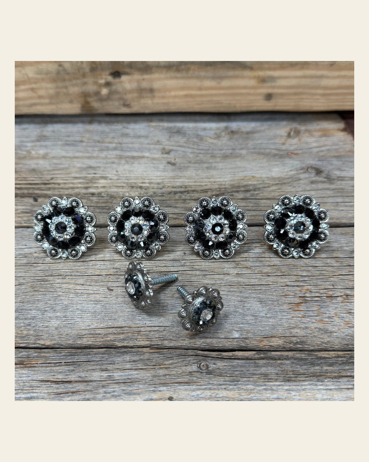 Antique Silver Jet and Clear Saddle Conchos on a warm cream background