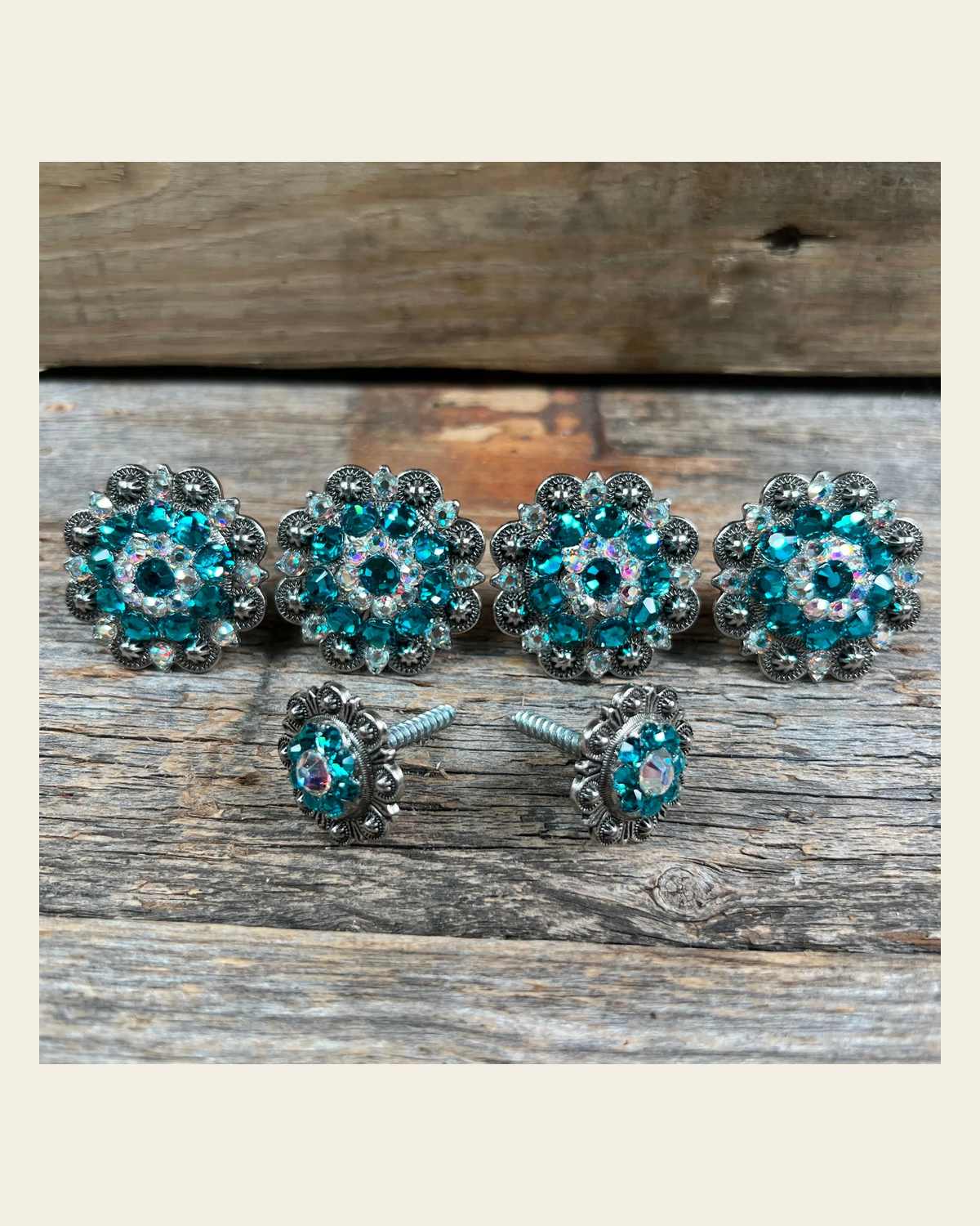 Antique Silver Teal & AB Saddle Conchos on a warm cream background