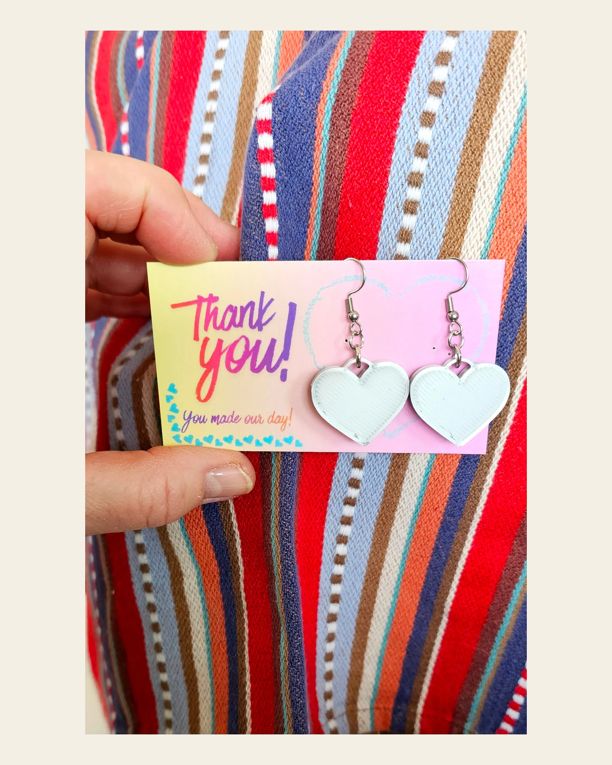 Bag of 20 -Boutique 3d Printed Package Inserts Heart Dangle Earrings Made in America on a warm cream background