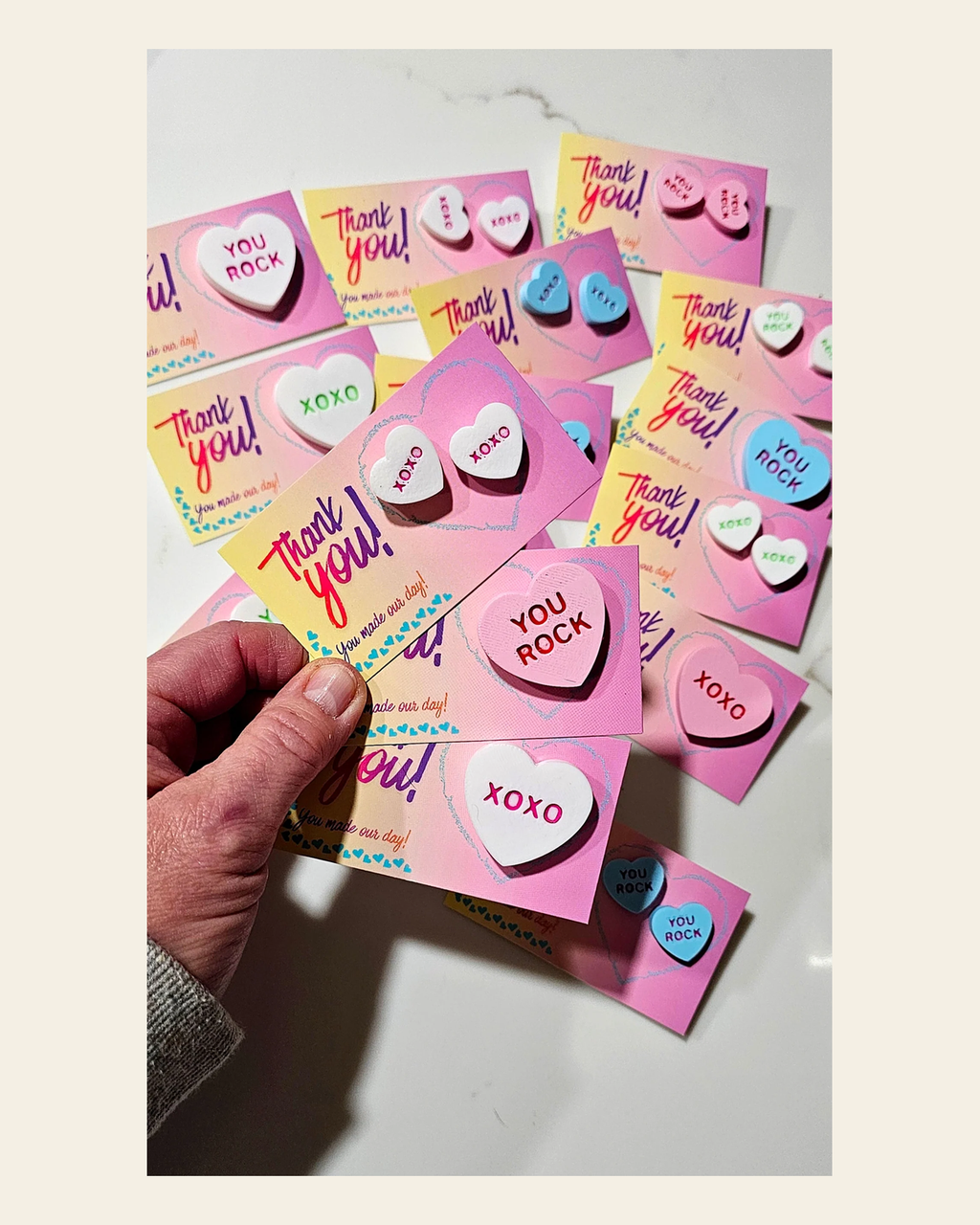 Bag of 25 -Boutique 3d Printed Package Inserts  Candy Message Heart Pins or Earrings Made in America on a warm cream background